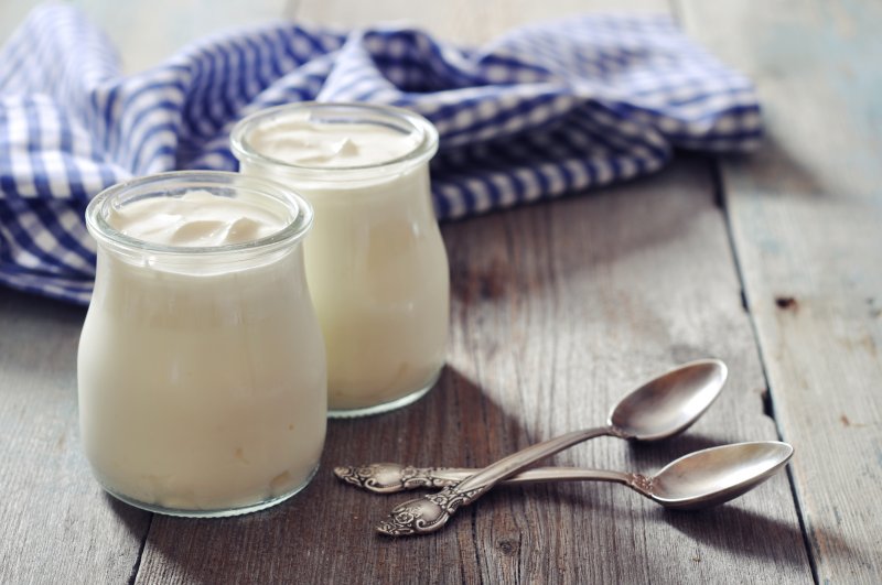 two small jars of yogurt and two spoons